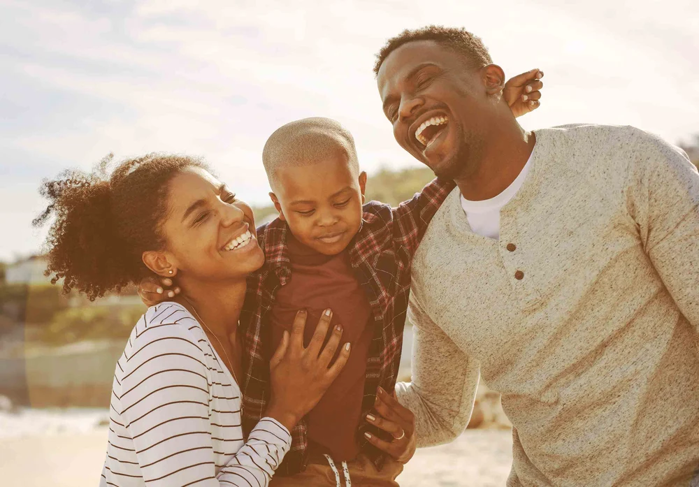 family-laughing-beach-travel-HGstock-676x338-1