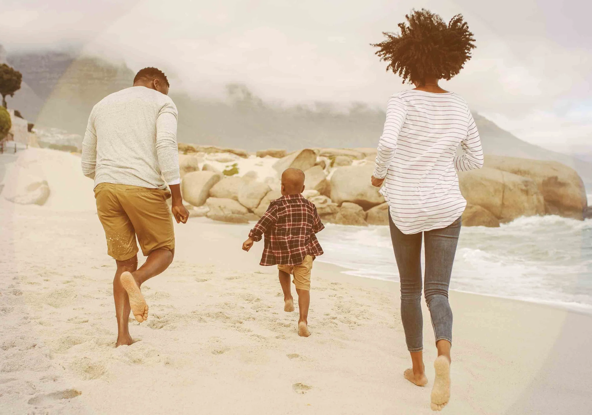 family-diverse-running-beach-travel-HGstock-676x338