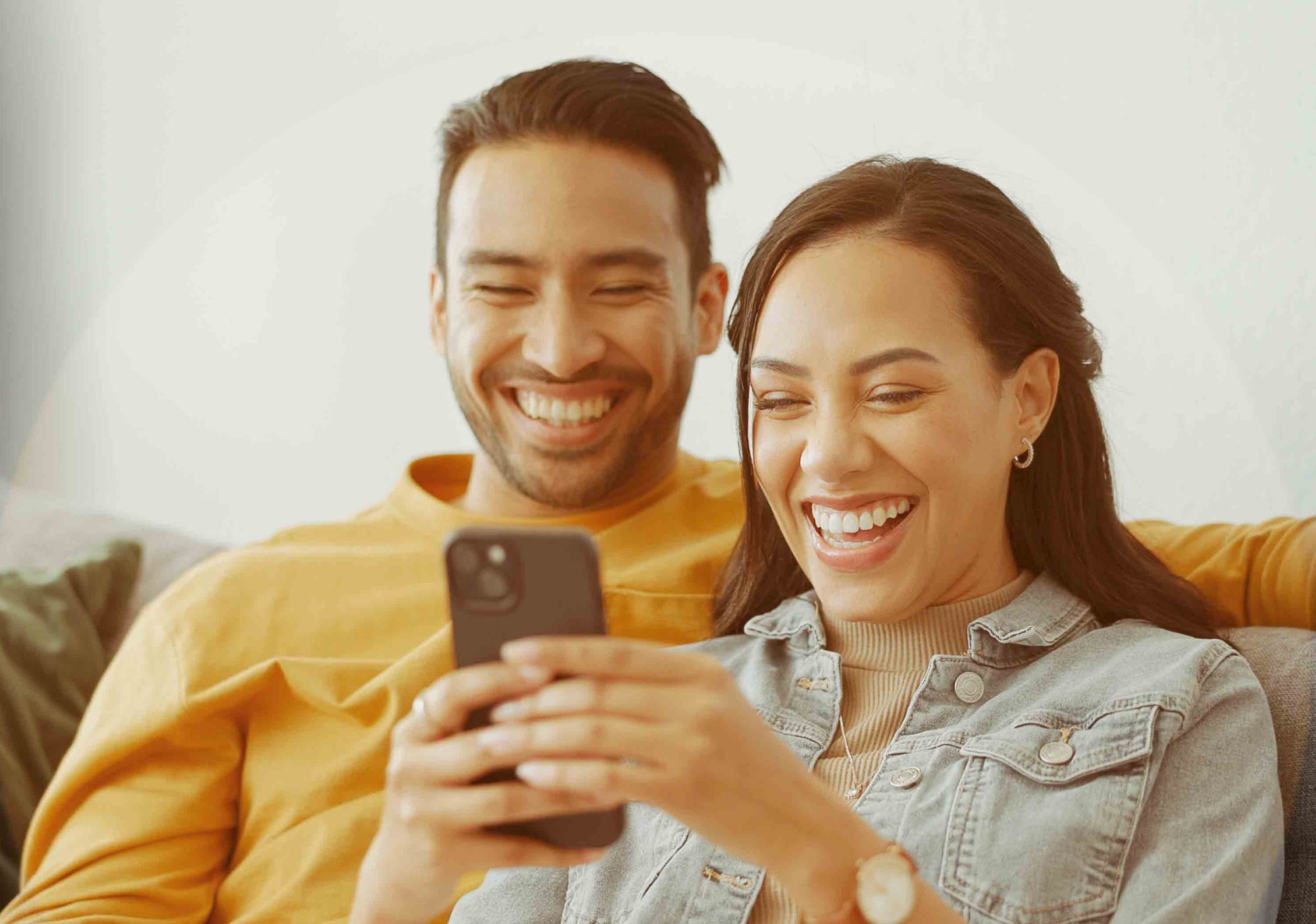young-couple-diverse-phone-happy-HGstock-676x338