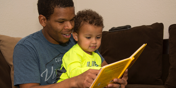 Dupaco member Damian Janisch reads to his son, Xzavier, in their Dickeyville, Wis., home. Thanks to swift action by his financial cooperative, Janisch’s money—and his Dupaco accounts—were secured when he became a victim of identity theft. (S. Gassman photo)