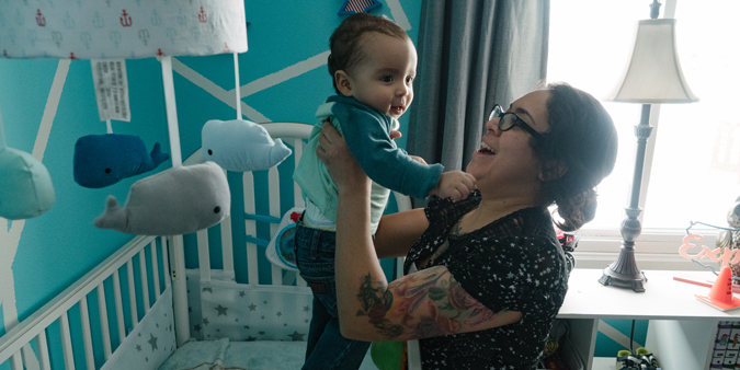 DupacoPriscillaEugene-18 Dupaco member Priscilla Delao picks up son Eugene from crib