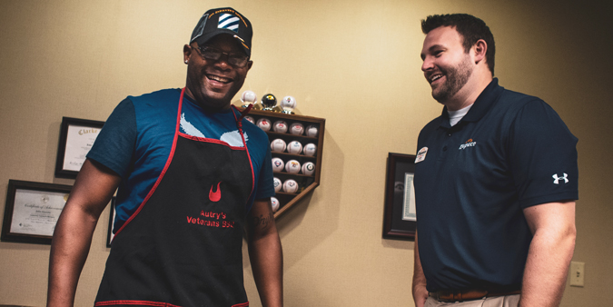 Dupaco member Monté Autry, owner of Autry’s Veterans BBQ and Catering Service, visits with Dupaco’s John Heavens