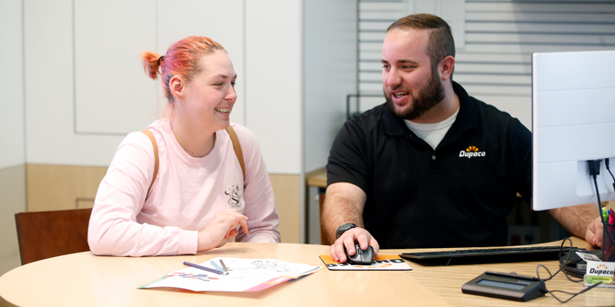 Dupaco member Anna Grimm visits with Dupaco’s Jake Bemis on May 28 at the credit union’s San Marnan Learning Lab in Waterloo, Iowa. (B. Pollock photo)