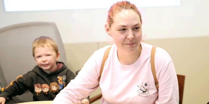Mother and son smile while visiting a Dupaco branch