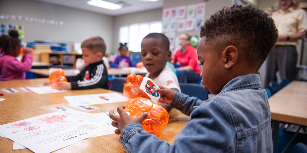 Tri-County Head Start students check out their new piggy banks.