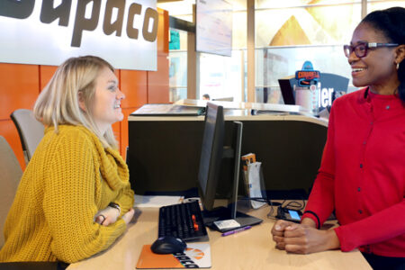 Member ReShonda Young, of Waterloo, Iowa, visits with Dupaco's Chloe Brown at the Mullan branch in Waterloo, Iowa. (B. Pollock photo)