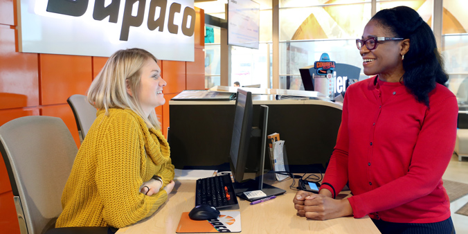 Member ReShonda Young, of Waterloo, Iowa, visits with Dupaco's Chloe Brown at the Mullan branch in Waterloo, Iowa. (B. Pollock photo)