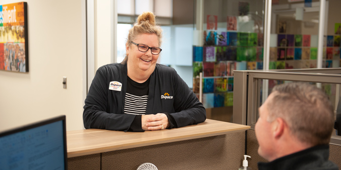 Dupaco Insurance Services’ Chris Rogers visits with coworker Jason Davis at Dupaco’s Pennsylvania Avenue branch in Dubuque, Iowa. (M. Blondin/Dupaco photo)