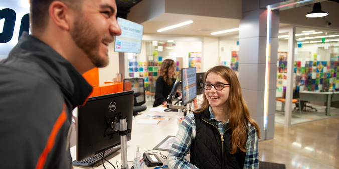 Emily, first-place winner of the Dupaco Great Credit Race, visits with her race coach, Noah Kachelski, at the Pennsylvania Avenue branch in Dubuque, Iowa. (M. Blondin/Dupaco photo)