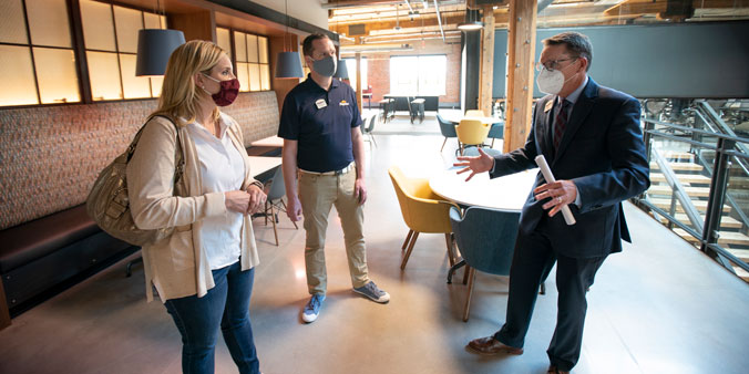 Dupaco President and CEO Joe Hearn (right) and director Andy Schroeder talk to U.S. Rep. Ashley Hinson (R-Iowa) during a May 6 tour of the recently completed Dupaco Voices Building in Dubuque, Iowa. Attendees discussed the economic impact that these historical renovation projects have on local communities. They also shared how credit unions are fulfilling their purpose to enhance the economic and social well-being of members every day. (M. Burley photo)