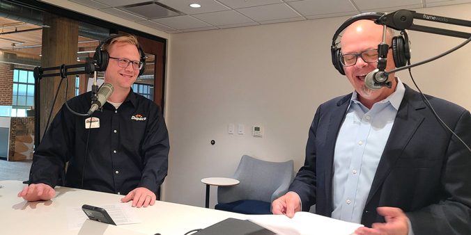 Dupaco's Dave Klavitter (right) shares a story with the credit union's Community Outreach & Education Manager Tony Viertel while recording in the Studio at the Dupaco Voices Building. (M. Blondin/Dupaco photo)