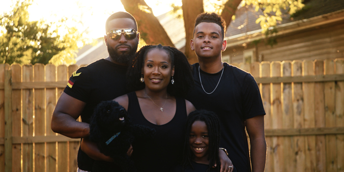 Leroy and Brittany Sisk and their sons Jaiden (back) and Dru enjoy spending time in their newly enclosed backyard. (DreamCatcher photo)