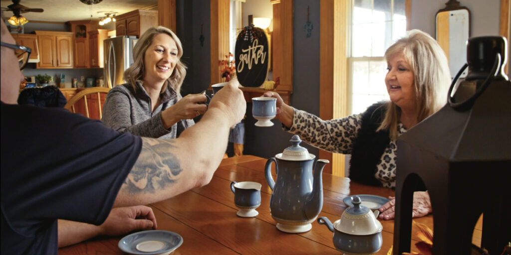 Members Caren (right) and Bill Sperfslage enjoy a visit from Dupaco's Amanda Bieber (center) in their rural Central City, Iowa, home. (DreamCatcher photo)