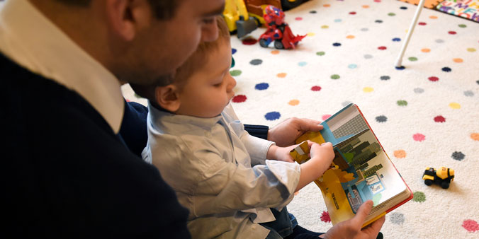 Chris Gantz reads a book to his son, Jackson, in their home. (K. Wolf photo)