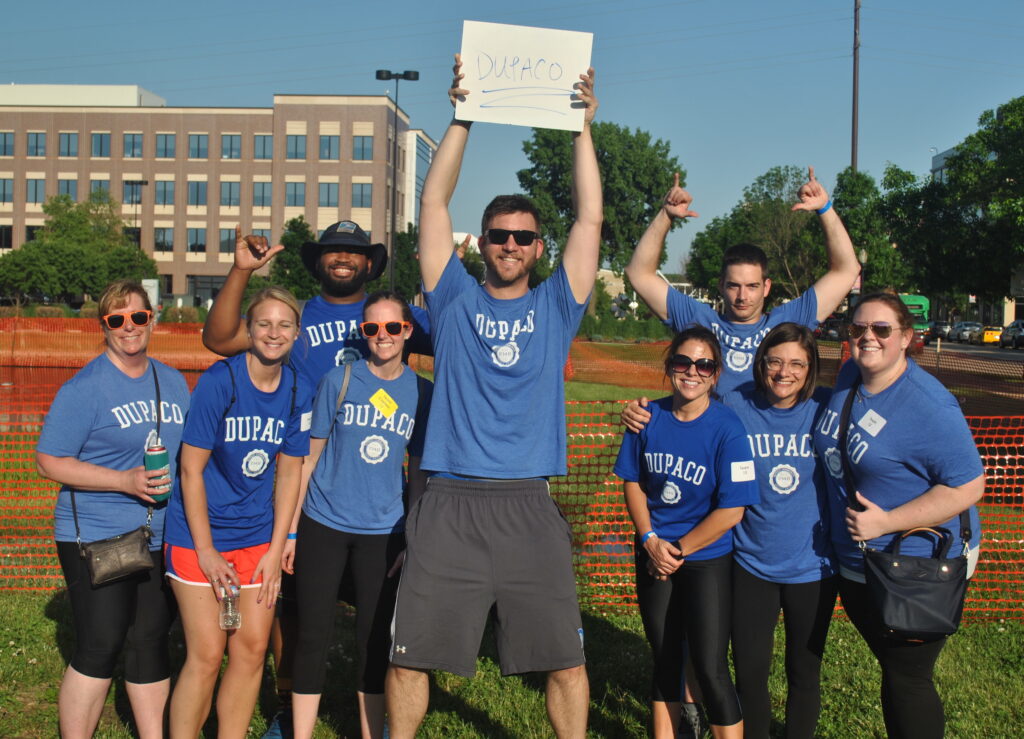 Group of Dupaco employees wearing blue Dupaco t-shirts at the ARC games in Dubuque, Iowa