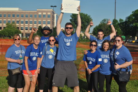 Group of Dupaco employees wearing blue Dupaco t-shirts at the ARC games in Dubuque, Iowa