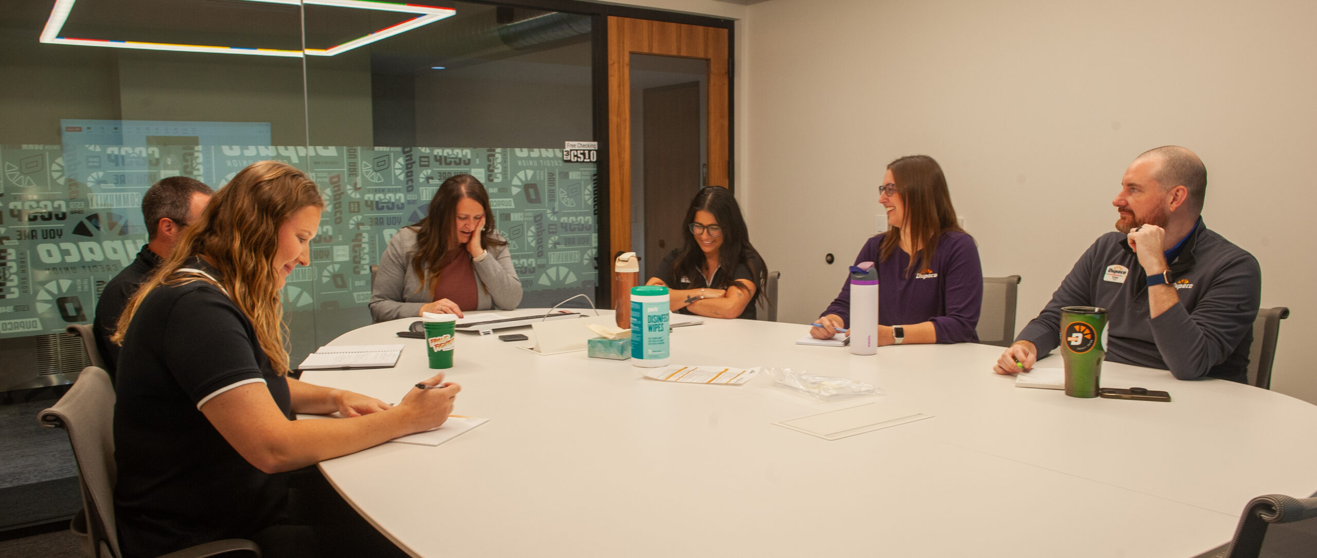 Dupaco’s fraud team collaborating in a conference room at the Operations Center to review emerging fraud trends—supporting members and front-line teams with timely insights and protection strategies.